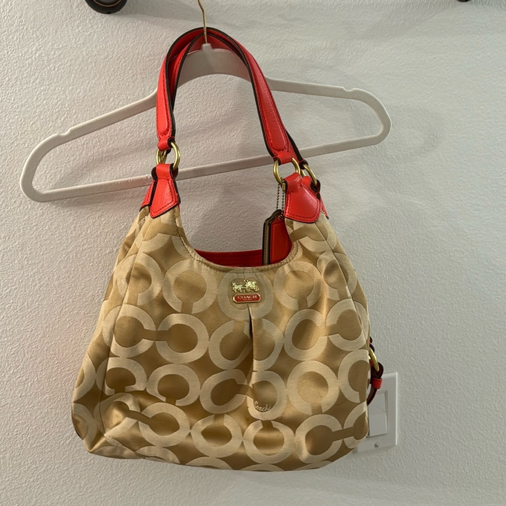 Gold coach purse with red orange leather accents